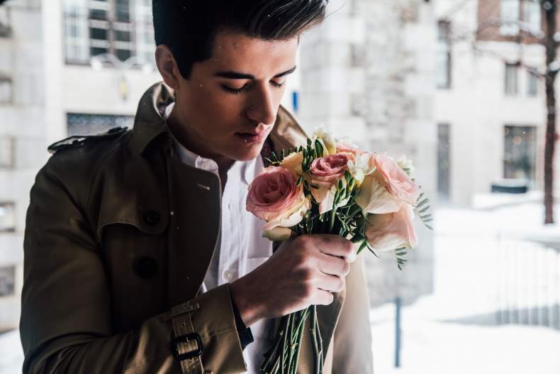 young man holding flowers